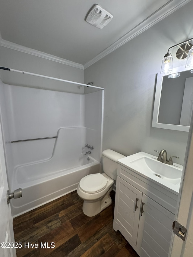 full bathroom with hardwood / wood-style flooring, shower / bath combination, vanity, toilet, and crown molding