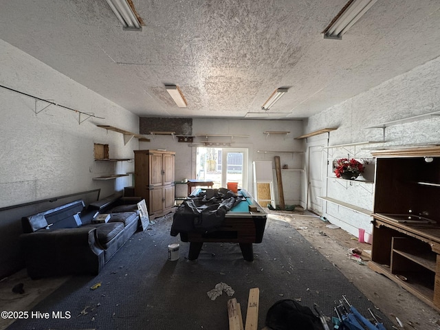 game room with a textured ceiling and billiards