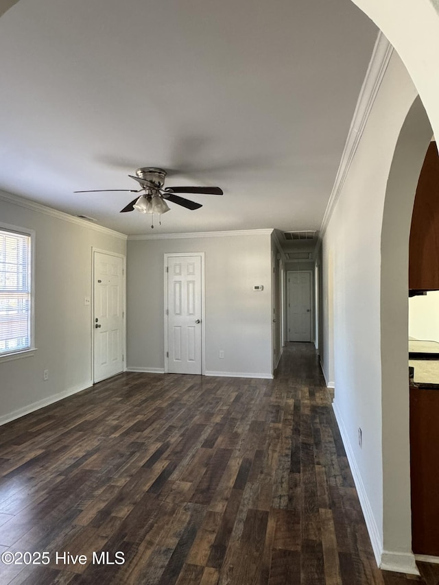 empty room featuring crown molding, dark hardwood / wood-style floors, and ceiling fan