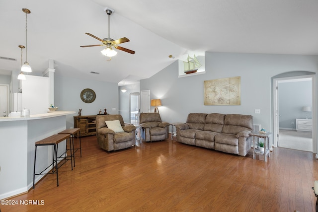 living room with ceiling fan, lofted ceiling, and dark hardwood / wood-style flooring