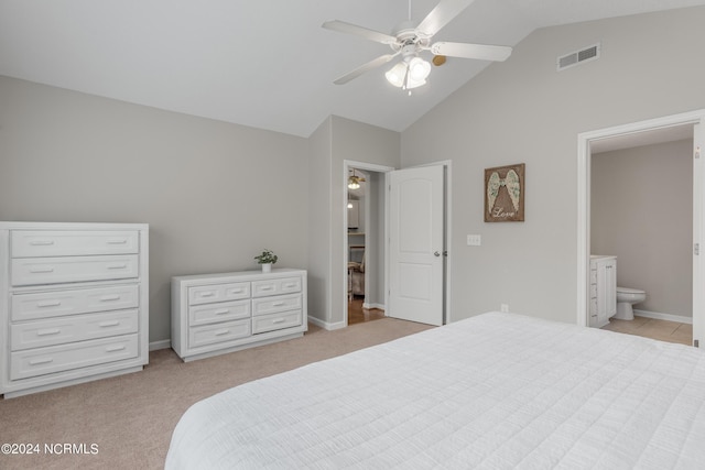 bedroom with ceiling fan, connected bathroom, high vaulted ceiling, and light carpet