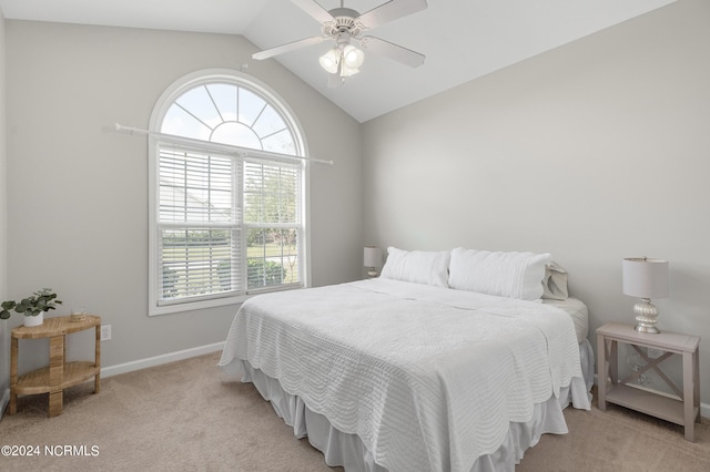 carpeted bedroom with ceiling fan and vaulted ceiling