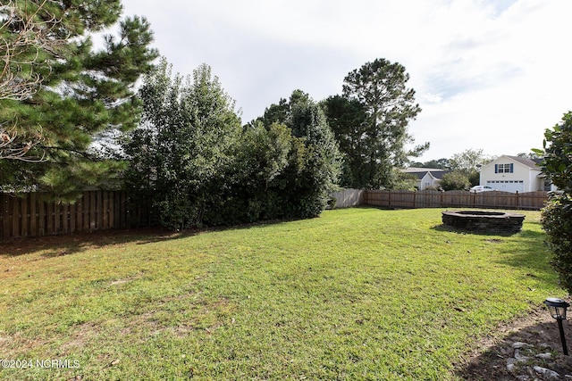 view of yard with an outdoor fire pit