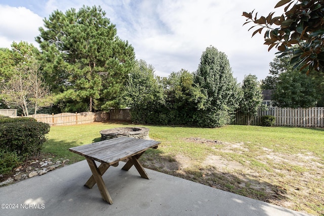 view of yard featuring a patio and an outdoor fire pit