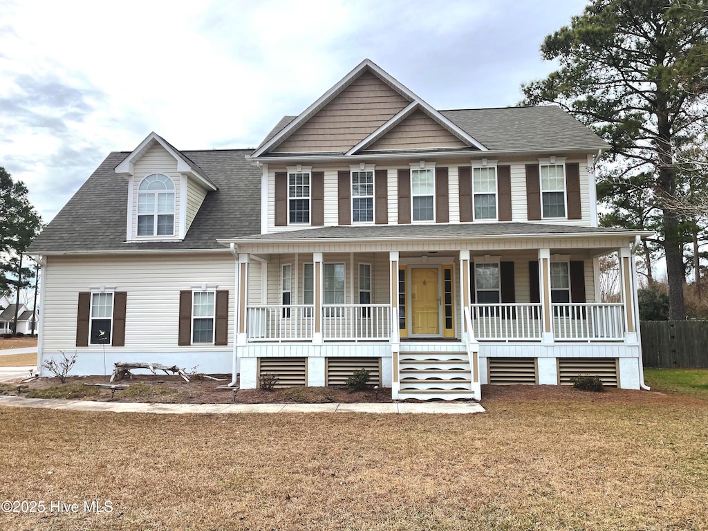 view of front of property with a front yard and covered porch