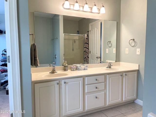 bathroom featuring tile patterned flooring, an enclosed shower, and vanity