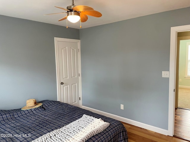 bedroom with ceiling fan and hardwood / wood-style flooring