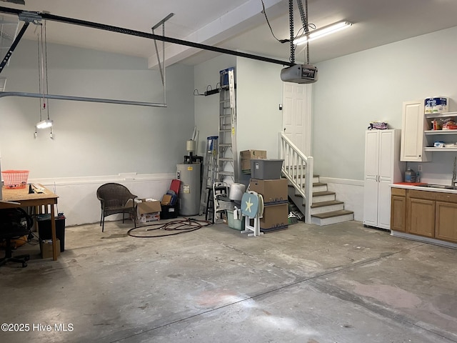 garage featuring sink, water heater, and a garage door opener