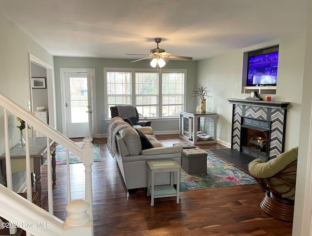 living room with ceiling fan, dark hardwood / wood-style floors, and a fireplace