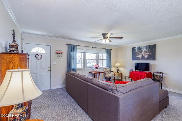 living area featuring a textured ceiling, ornamental molding, carpet, and a ceiling fan