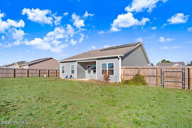 rear view of property featuring a yard