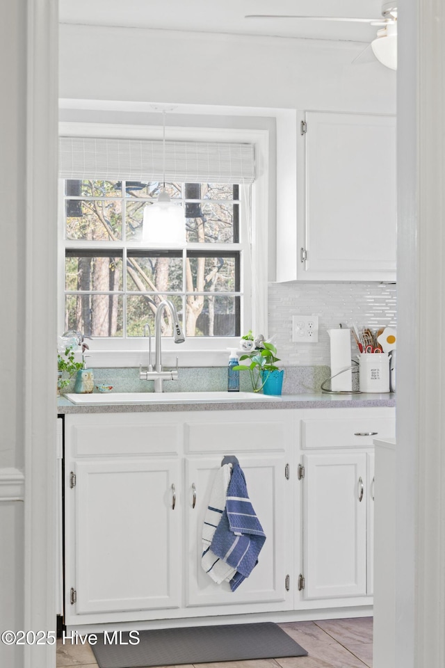 bar featuring backsplash and white cabinets