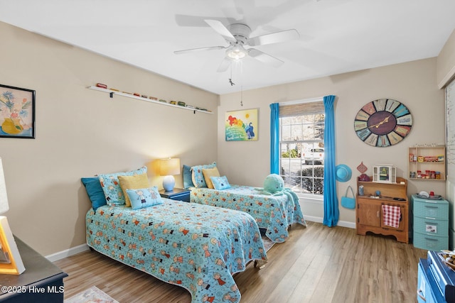 bedroom with ceiling fan and light hardwood / wood-style flooring