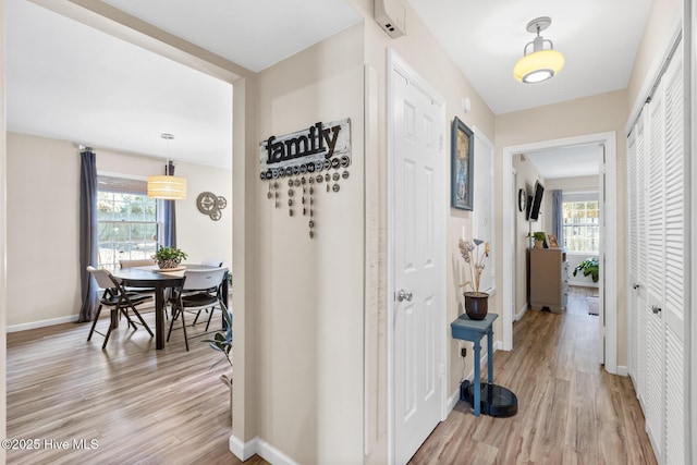 hall with light hardwood / wood-style flooring