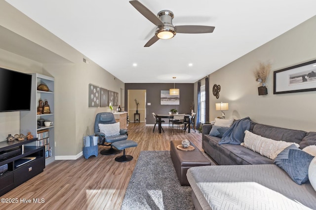 living room featuring hardwood / wood-style flooring and ceiling fan