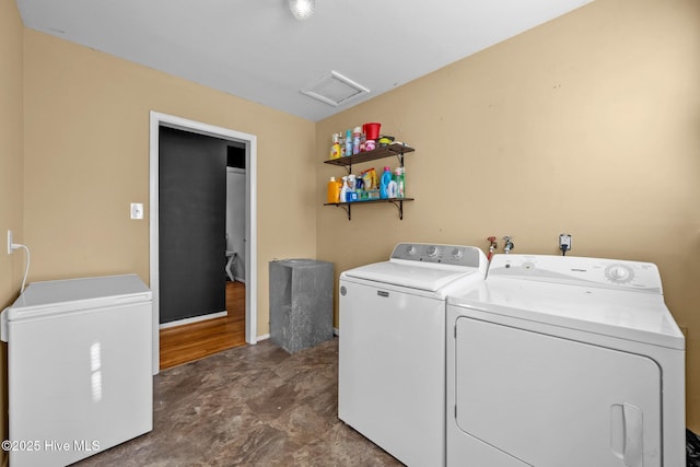 clothes washing area featuring washer and clothes dryer