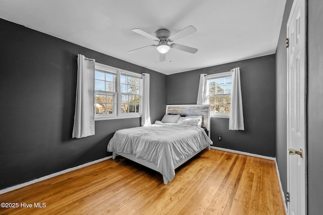 bedroom with ceiling fan and light hardwood / wood-style floors