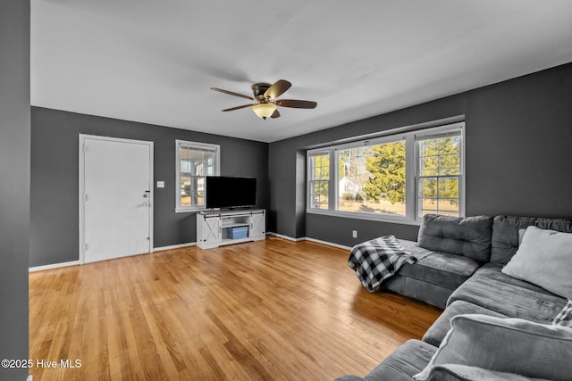 unfurnished living room featuring ceiling fan and light hardwood / wood-style floors