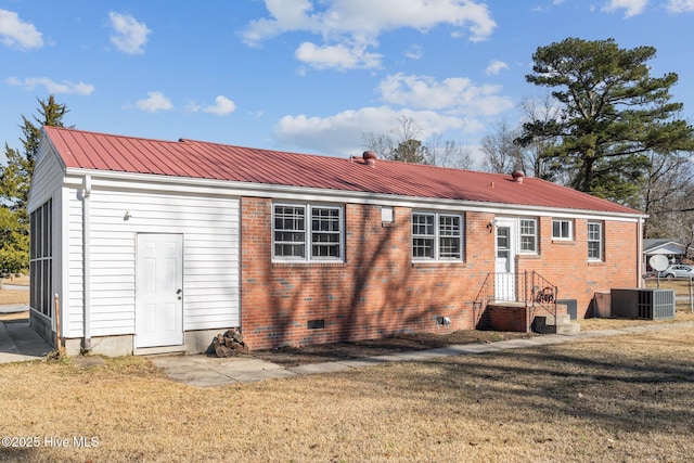 back of house featuring cooling unit and a yard