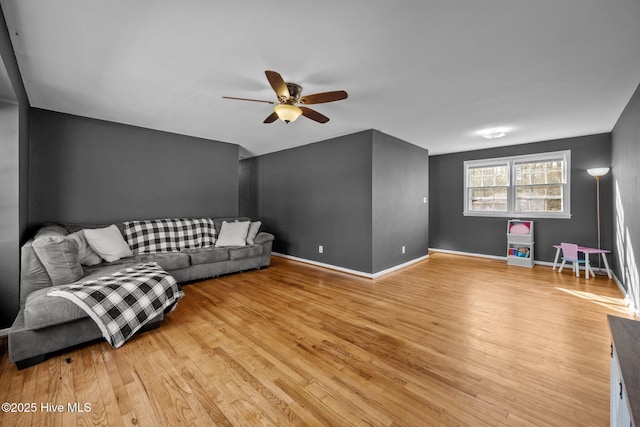 living room featuring light hardwood / wood-style floors and ceiling fan