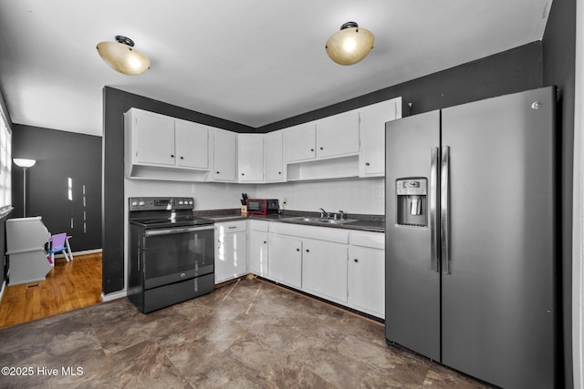 kitchen with stainless steel refrigerator with ice dispenser, white cabinets, electric range, and sink