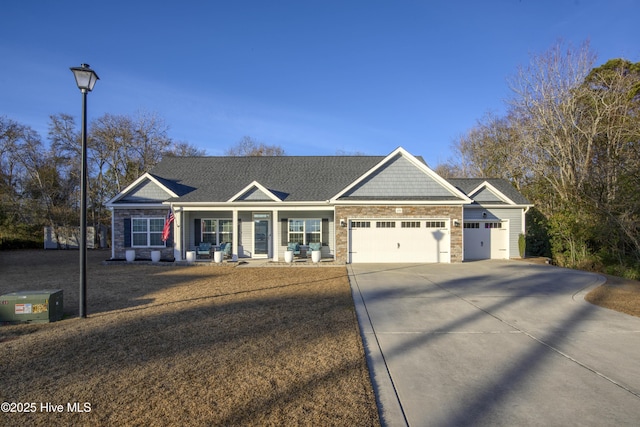 view of front of property with covered porch and a garage