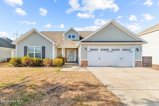 view of front of property with a garage and a front lawn