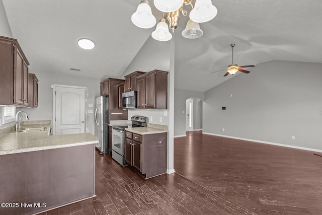 kitchen featuring sink, decorative light fixtures, dark brown cabinets, appliances with stainless steel finishes, and dark hardwood / wood-style flooring