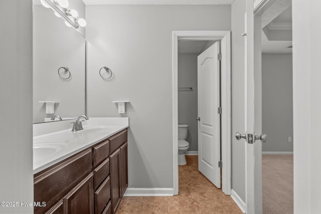 bathroom with tile patterned floors, vanity, and toilet