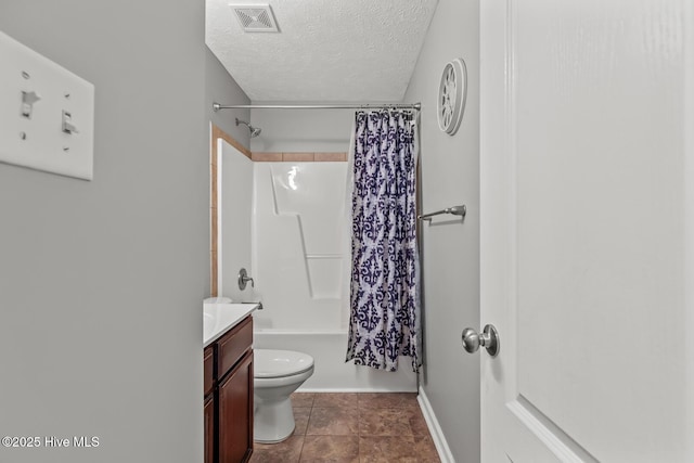 full bathroom featuring vanity, shower / tub combo with curtain, a textured ceiling, and toilet