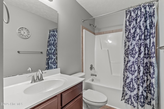 full bathroom with vanity, toilet, a textured ceiling, and shower / bath combo