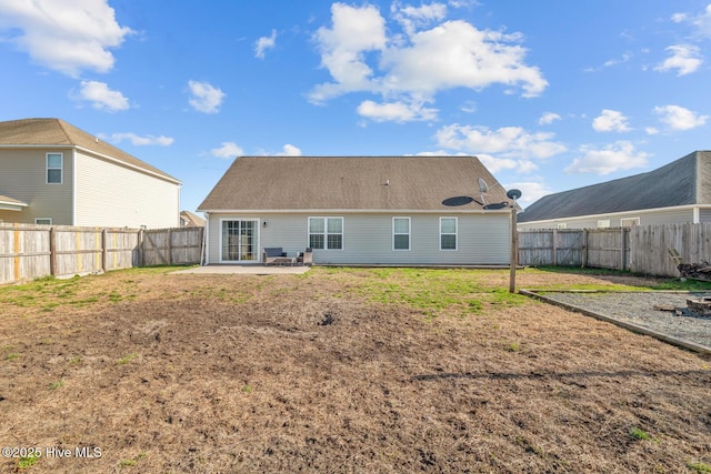 rear view of house with a patio and a lawn