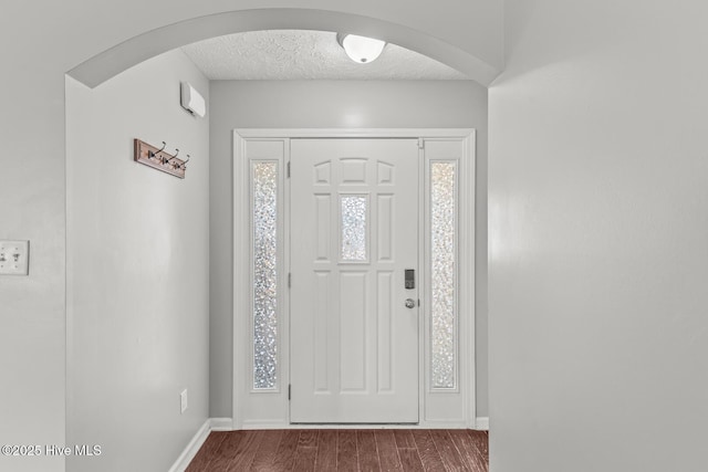 entrance foyer featuring dark hardwood / wood-style floors and a textured ceiling