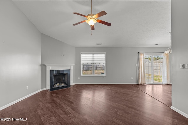 unfurnished living room featuring a tile fireplace, wood-type flooring, and ceiling fan