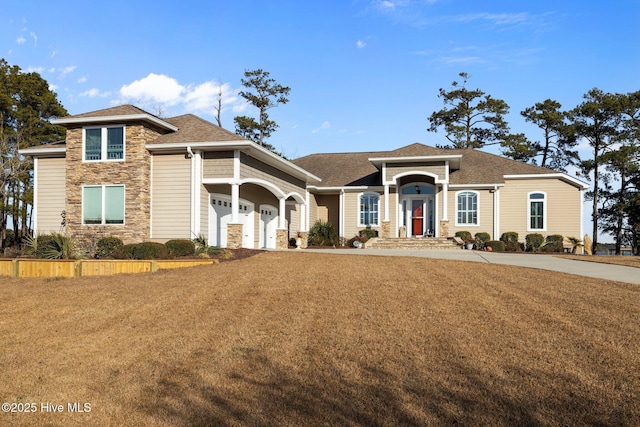 view of front of property with a garage and a front yard