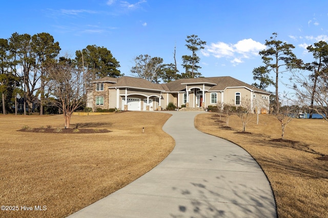 view of front of house with a garage and a front yard