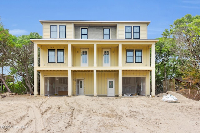 3804 Emerald Dr E, Emerald Isle, NC 28594 - raised beach house featuring board and batten siding and an attached garage