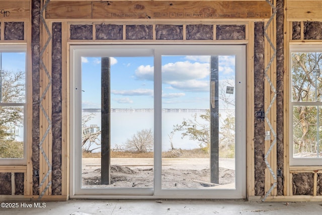 doorway to outside with plenty of natural light and a water view