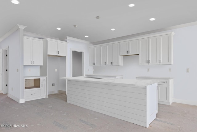 3804 Emerald Dr E, Emerald Isle, NC 28594 - kitchen with crown molding, baseboards, white cabinets, and a kitchen island