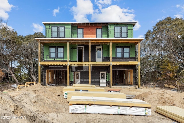 rear view of property featuring a balcony