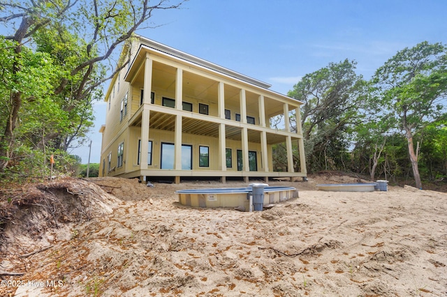 3804 Emerald Dr E, Emerald Isle, NC 28594 - rear view of property with board and batten siding and a balcony