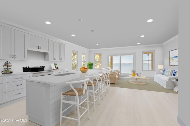 3804 Emerald Dr E, Emerald Isle, NC 28594 - kitchen featuring recessed lighting, ornamental molding, light wood finished floors, and open floor plan