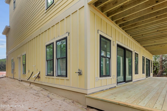 3804 Emerald Dr E, Emerald Isle, NC 28594 - view of side of home with board and batten siding and a wooden deck