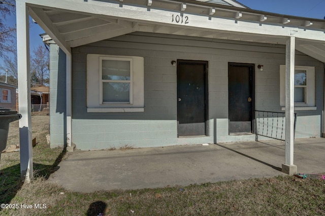 view of exterior entry featuring a porch