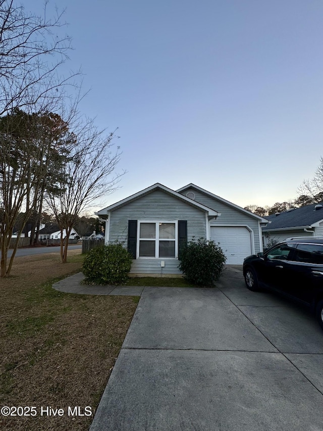 view of front of property with a front yard and a garage