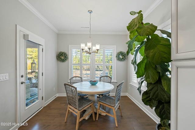 dining room featuring ornamental molding, dark hardwood / wood-style floors, and a notable chandelier