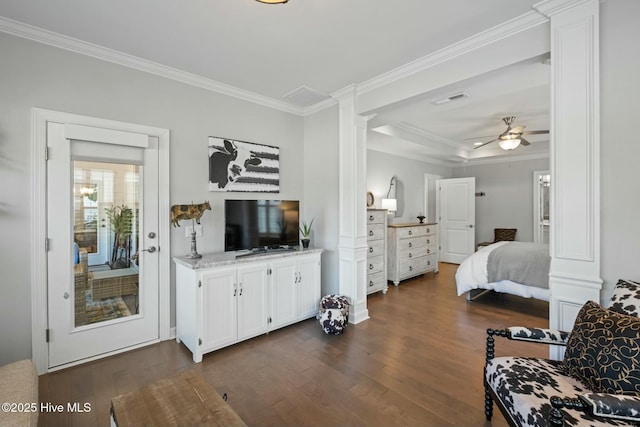 bedroom with a tray ceiling, ornamental molding, and dark hardwood / wood-style floors