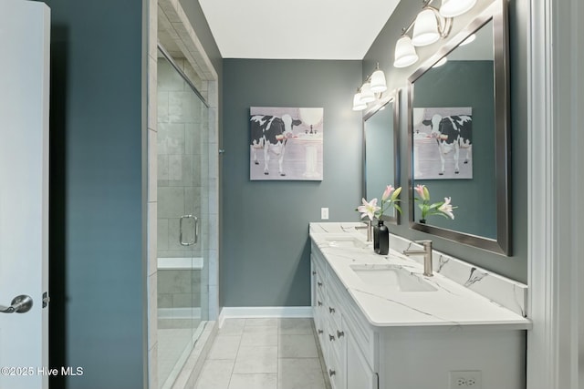 bathroom with a shower with door, vanity, and tile patterned floors