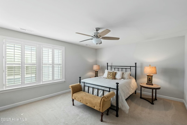 bedroom with light carpet and ceiling fan