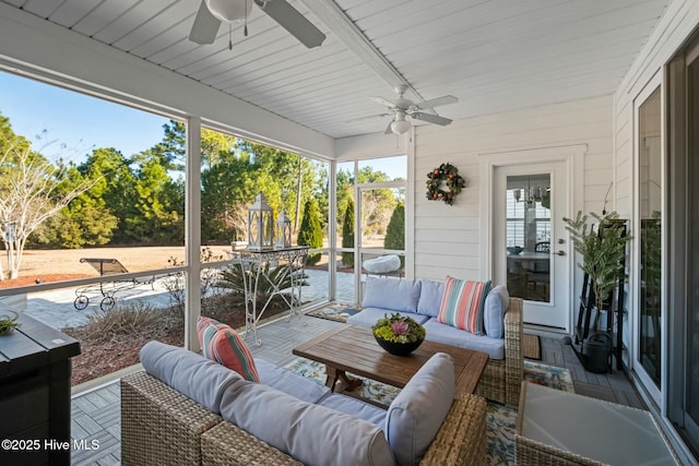 sunroom featuring ceiling fan